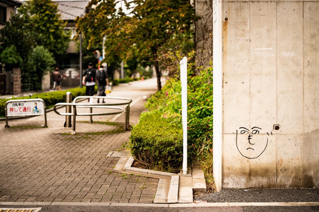 A へのへのもへじ face as a graffito on a support column for an elevated train line, as seen in Kita-ku, Tokyo